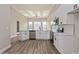 Modern kitchen featuring white cabinets, stainless steel appliances, and a breakfast bar overlooking the living space at 5357 Greystone Dr, Spring Hill, FL 34609