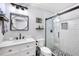 Modern bathroom features tiled shower with glass door and a vanity with stylish fixtures at 5903 War Admiral Dr, Wesley Chapel, FL 33544