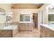 Beautiful bathroom with a glass-enclosed shower, a large bathtub, double vanities, and tile flooring at 5903 War Admiral Dr, Wesley Chapel, FL 33544