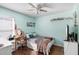 Cozy bedroom with ceiling fan, decor, and hardwood floors, bathed in natural light at 5903 War Admiral Dr, Wesley Chapel, FL 33544
