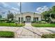 Community clubhouse featuring a grand entrance with white columns, beautifully landscaped at 5903 War Admiral Dr, Wesley Chapel, FL 33544