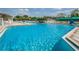 Large community pool area with ample seating and shade, perfect for relaxation and socializing at 5903 War Admiral Dr, Wesley Chapel, FL 33544