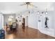 Bright and airy living room featuring hardwood floors, neutral walls, an elegant ceiling fan, and an open floor plan at 5903 War Admiral Dr, Wesley Chapel, FL 33544