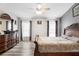 Spacious main bedroom featuring hardwood floors, a ceiling fan, neutral walls, and plenty of natural light at 5903 War Admiral Dr, Wesley Chapel, FL 33544