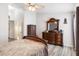 Bright main bedroom with hardwood floors, ceiling fan, large dresser, and a view of the backyard at 5903 War Admiral Dr, Wesley Chapel, FL 33544