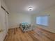 Bright bedroom featuring wood floors, a double bed with floral sheets, a window, and a closet at 610 Cobia Way, Oldsmar, FL 34677