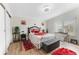 This bedroom features a bed with red rose bedding and a decorative headboard at 610 Cobia Way, Oldsmar, FL 34677