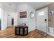 Bright foyer features wood-look flooring and a front door with a pet door at 610 Cobia Way, Oldsmar, FL 34677