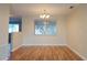 Inviting dining area with hardwood floors and a chandelier, perfect for intimate gatherings at 6301 Baldwyn Ave, New Port Richey, FL 34653