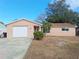 Charming single-story home featuring an attached garage, manicured lawn, and well-maintained landscaping at 6301 Baldwyn Ave, New Port Richey, FL 34653
