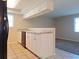 Well-lit kitchen features granite countertops, white cabinets, and stainless steel dishwasher at 6301 Baldwyn Ave, New Port Richey, FL 34653