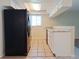 Updated kitchen with stainless steel appliances, white cabinets and a tile floor at 6301 Baldwyn Ave, New Port Richey, FL 34653