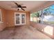 Enclosed patio with ceiling fan and lots of light, accessed through double doors at 6301 Baldwyn Ave, New Port Richey, FL 34653