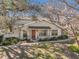 Beautiful home exterior featuring mature trees and lush landscaping at 6330 Woodspray Ln, Temple Terrace, FL 33617