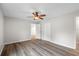 Bedroom with gray walls, wood look floors, and an overhead ceiling fan at 6358 Dakota Dr, Brooksville, FL 34602