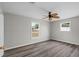 This bedroom has a ceiling fan, gray walls, and wood-look vinyl floors at 6358 Dakota Dr, Brooksville, FL 34602