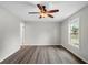 This bedroom has a ceiling fan, gray walls, and wood-look vinyl floors at 6358 Dakota Dr, Brooksville, FL 34602