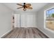 Bedroom with gray walls, wood look floors, and an overhead ceiling fan at 6358 Dakota Dr, Brooksville, FL 34602
