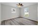 This bedroom offers two windows, ceiling fan, and neutral paint palette at 6358 Dakota Dr, Brooksville, FL 34602