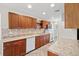 Well-equipped kitchen featuring granite countertops, wooden cabinets, and modern appliances at 6358 Dakota Dr, Brooksville, FL 34602