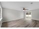 Bright living room with wood-look floors and sliding glass door to patio at 6358 Dakota Dr, Brooksville, FL 34602