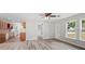 Bright living space with new floors, fresh paint, and an open layout leading to the kitchen at 6358 Dakota Dr, Brooksville, FL 34602