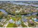 Aerial view of a residential neighborhood with waterfront homes, private docks, and canal access to open water at 646 Riverside Dr, Tarpon Springs, FL 34689