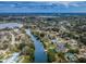 Expansive aerial view of waterfront community, showcasing canal access, lush greenery, and numerous residences at 646 Riverside Dr, Tarpon Springs, FL 34689