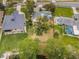 Aerial shot of a property showcasing the home, large backyard, surrounding neighborhood and landscaping at 646 Riverside Dr, Tarpon Springs, FL 34689