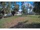 Spacious backyard featuring mature trees and secure fencing, perfect for outdoor activities at 646 Riverside Dr, Tarpon Springs, FL 34689