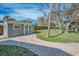 Backyard with shed, green grass, fence, and trees at 646 Riverside Dr, Tarpon Springs, FL 34689