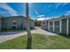 View of the backyard featuring the house, shed and lawn at 646 Riverside Dr, Tarpon Springs, FL 34689