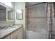 Bathroom with tiled floors, bathtub with shower, and a granite vanity at 646 Riverside Dr, Tarpon Springs, FL 34689
