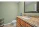 Half bath featuring a granite countertop and wood vanity at 646 Riverside Dr, Tarpon Springs, FL 34689
