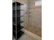 Shower with neutral colored tiles and built in shelving at 646 Riverside Dr, Tarpon Springs, FL 34689