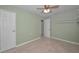 Bedroom featuring tiled flooring, a ceiling fan, and shelving at 646 Riverside Dr, Tarpon Springs, FL 34689