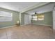 Bright bedroom space with tile flooring, a ceiling fan, and natural light filtering through the windows at 646 Riverside Dr, Tarpon Springs, FL 34689