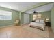 Light-filled bedroom featuring a cozy upholstered bed, neutral carpet, and closet storage at 646 Riverside Dr, Tarpon Springs, FL 34689