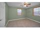 Bedroom with tiled floors, shelving, ceiling fan, and dual windows at 646 Riverside Dr, Tarpon Springs, FL 34689