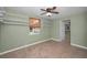 Bedroom with tiled flooring, ceiling fan, window, and shelving at 646 Riverside Dr, Tarpon Springs, FL 34689