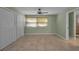 Empty bedroom showcasing tile flooring, natural light, and neutral wall color at 646 Riverside Dr, Tarpon Springs, FL 34689
