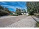 Long brick paver driveway and mature landscaping enhance the curb appeal of this property at 646 Riverside Dr, Tarpon Springs, FL 34689