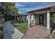Inviting front entrance with a brick pathway and white columns, leading to a welcoming dark wood door at 646 Riverside Dr, Tarpon Springs, FL 34689