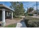 Charming home entrance with brick walkway, lush greenery, and a welcoming front door at 646 Riverside Dr, Tarpon Springs, FL 34689