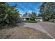 Charming home with a brick driveway framed by lush greenery, offering great curb appeal at 646 Riverside Dr, Tarpon Springs, FL 34689