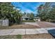 Charming home with a brick driveway framed by lush greenery, offering great curb appeal at 646 Riverside Dr, Tarpon Springs, FL 34689