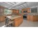 Spacious kitchen with granite countertops, a center island, and stainless steel appliances at 646 Riverside Dr, Tarpon Springs, FL 34689
