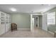 Spacious living room with tiled floors, built in storage, and a wicker chair at 646 Riverside Dr, Tarpon Springs, FL 34689