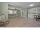 Living room area with tile flooring, natural light, and a cozy seating arrangement near built-in cabinets at 646 Riverside Dr, Tarpon Springs, FL 34689