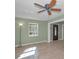 Bright living room with tile floors, a ceiling fan, and large windows for ample natural light at 646 Riverside Dr, Tarpon Springs, FL 34689